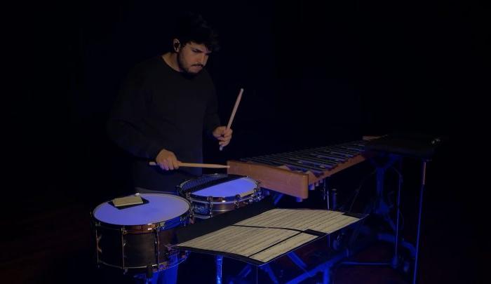 A person playing a set of snare drums